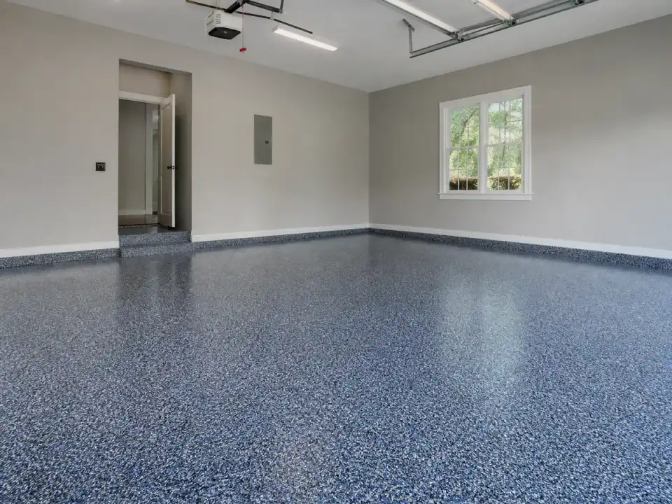 Garage Glow Final Blue-and-black flake polyaspartic coating on a Marietta garage floor