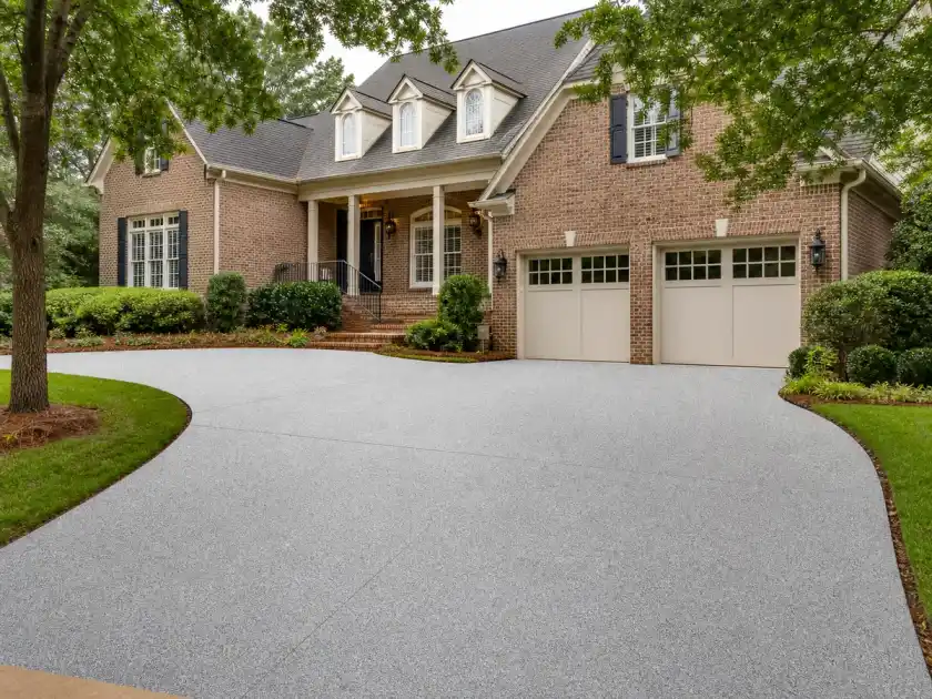 Light gray decorative driveway coating at a brick Atlanta home